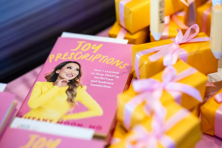 Joy Prescriptions by Dr. Tiffany Moon with gift boxes at ACE Scholarships luncheon Denver