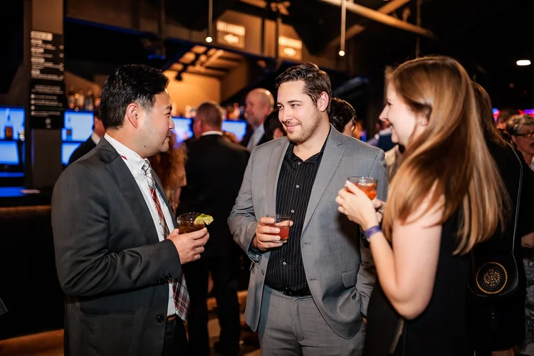 Guests networking at cocktail hour bar at Denver Broncos Honors Awards Mission Ballroom RiNo