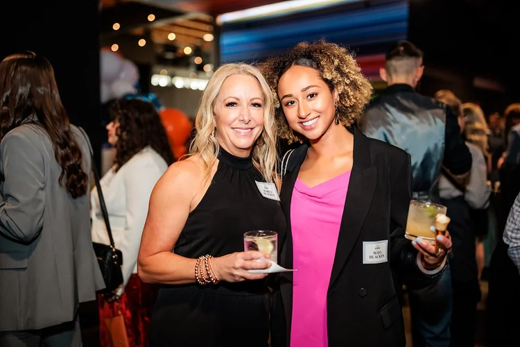 Two women at Broncos Honors cocktail hour Mission Ballroom Denver corporate event photography
