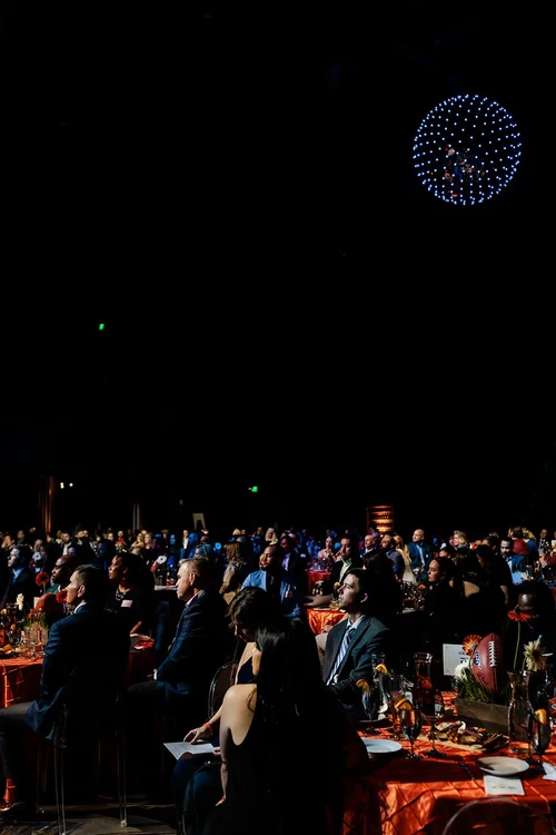 Wide audience shot with drone light display overhead at Denver Broncos Honors Awards Mission Ballroom