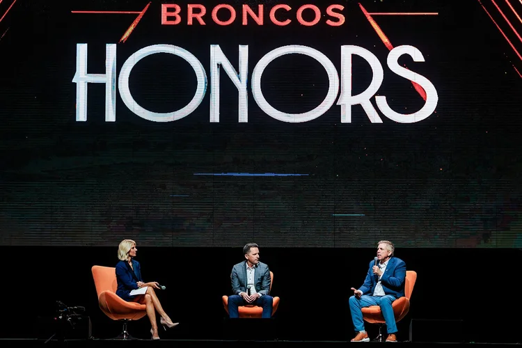Wide stage view of Broncos Honors panel discussion with full audience at Mission Ballroom Denver