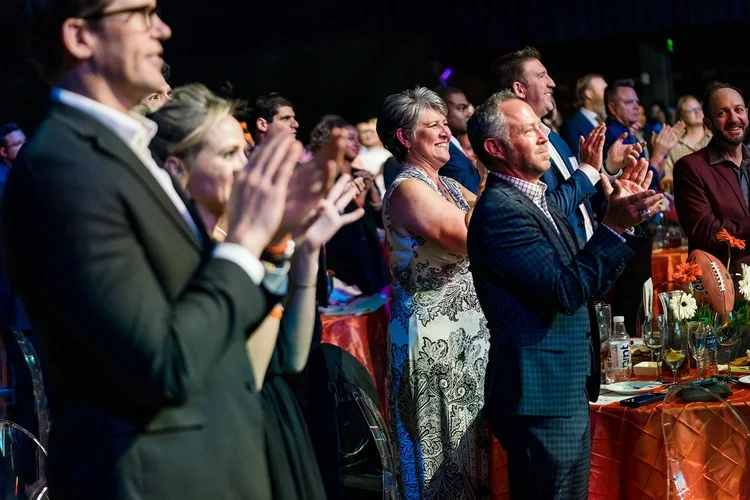 Audience standing ovation at Denver Broncos Honors Awards Mission Ballroom Denver Colorado