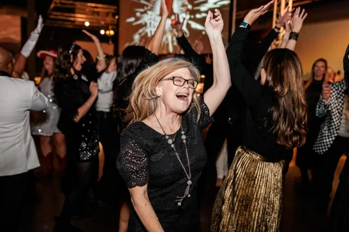 Guests on dance floor at corporate holiday party Parker Colorado