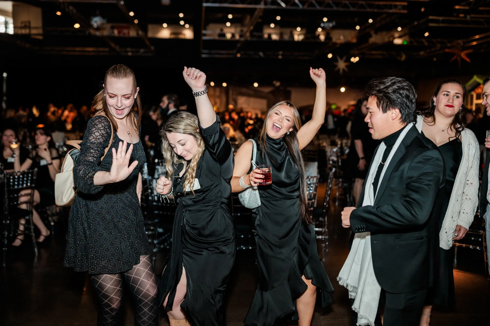 Guests dancing at corporate holiday party at Vehicle Vault Parker Colorado