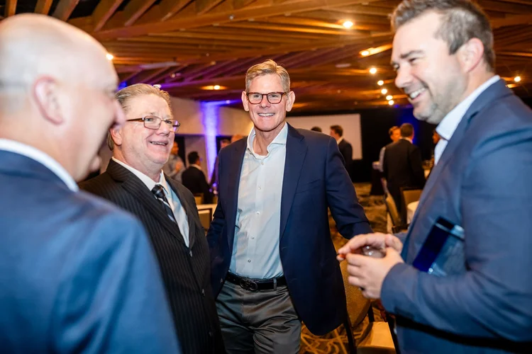 Award recipient holding trophy on stage corporate event photography Denver Colorado