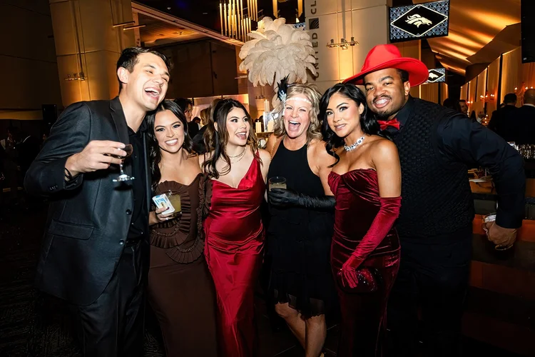 Group photo corporate holiday party event photography Denver Broncos Empower Field