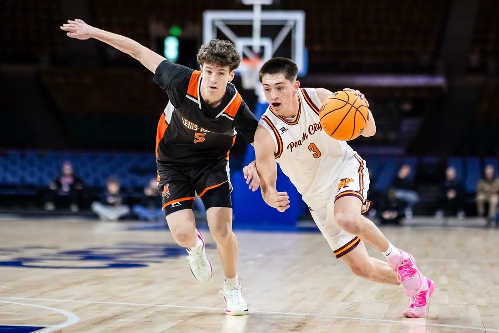 Palisade head coach on sideline during Colorado high school basketball playoff game Denver