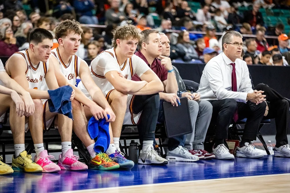 Lewis-Palmer players celebrating after beating Palisade in Colorado 5A basketball playoffs Denver Coliseum