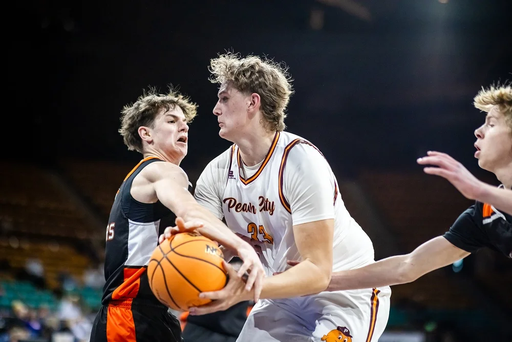Palisade player fighting for the ball against Lewis-Palmer defender Denver Coliseum