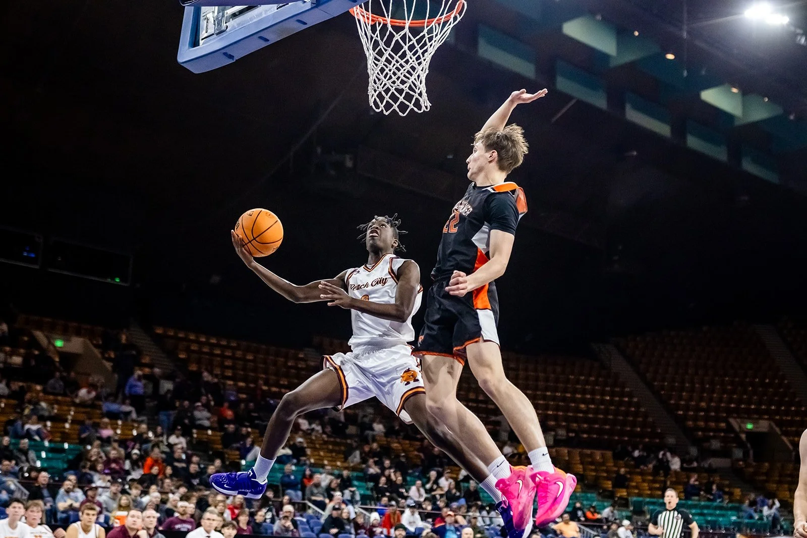 Palisade player driving to the basket during 5A basketball playoff game at Denver Coliseum