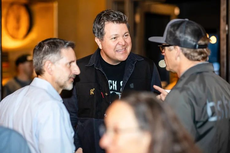 Candid networking conversation at Denver corporate event Stranahan's Distillery