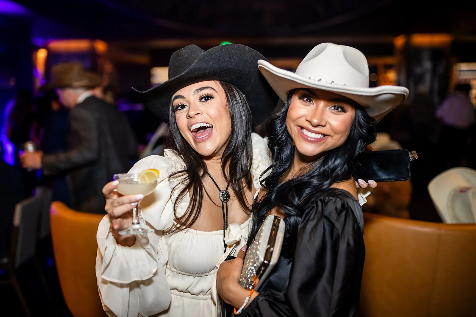 corporate holiday party guests in western attire at Empower Field Denver Colorado