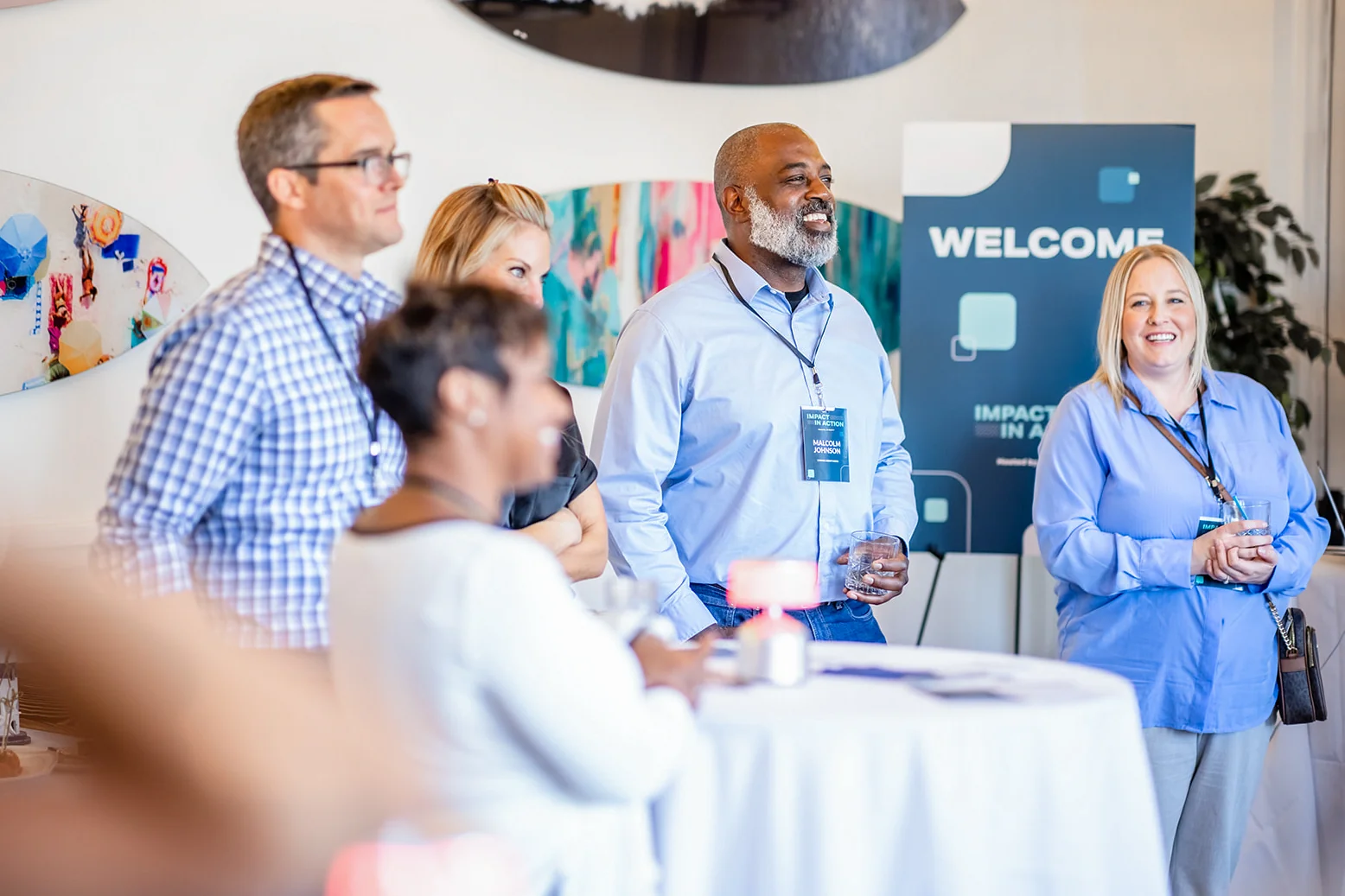 corporate networking event photography with attendees and welcome signage Denver Colorado