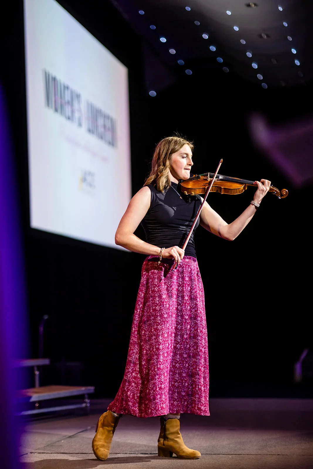 Violin performer on stage charity event photography Seawell Ballroom Denver Colorado